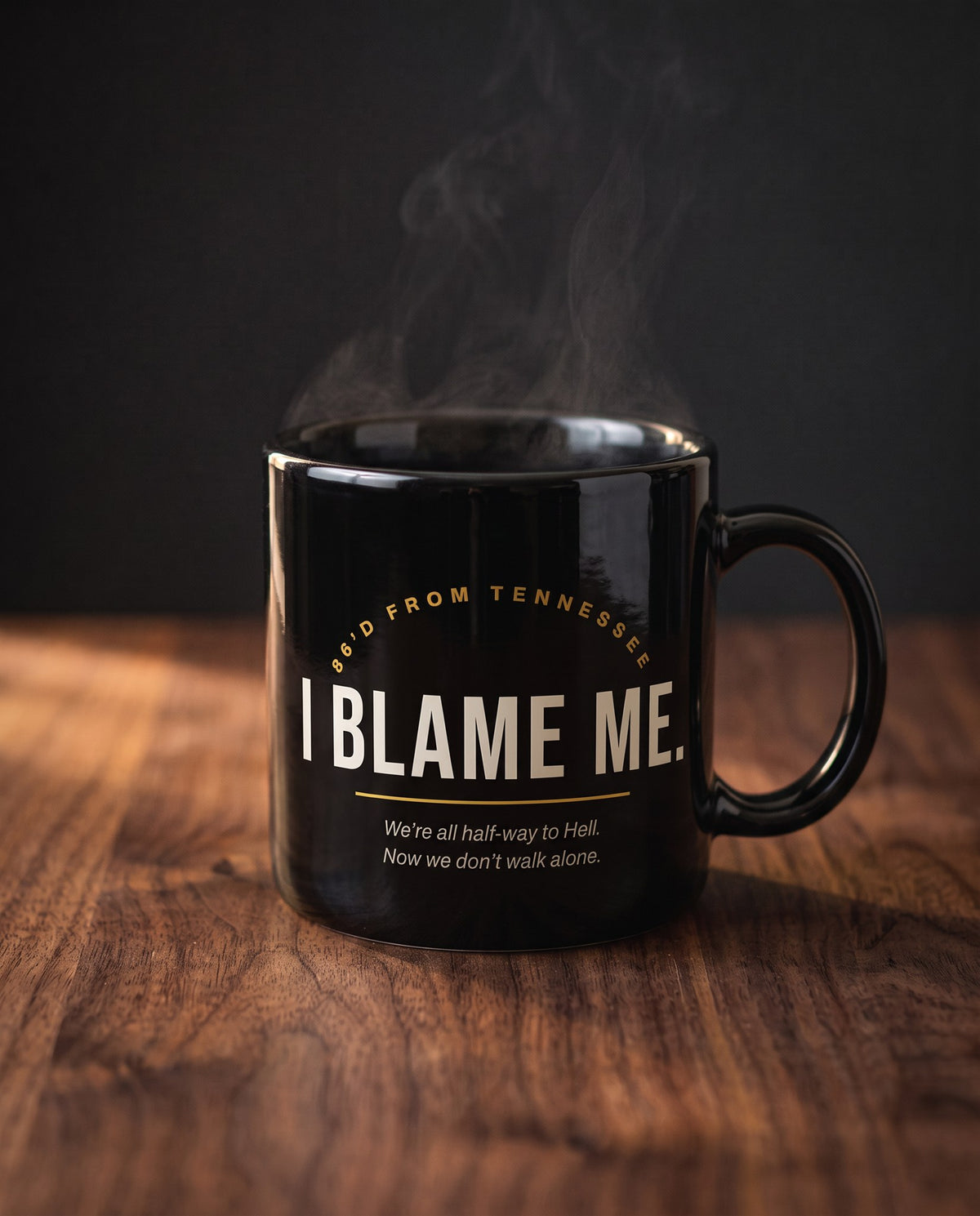 I Blame Me Black Mug on a wood table