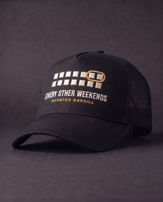 Every Other Weekends A-Frame Trucker — black mesh-back trucker with calendar embroidery